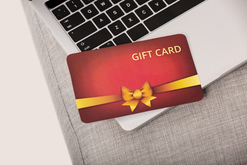 An image of a gift card voucher placed on top of a laptop