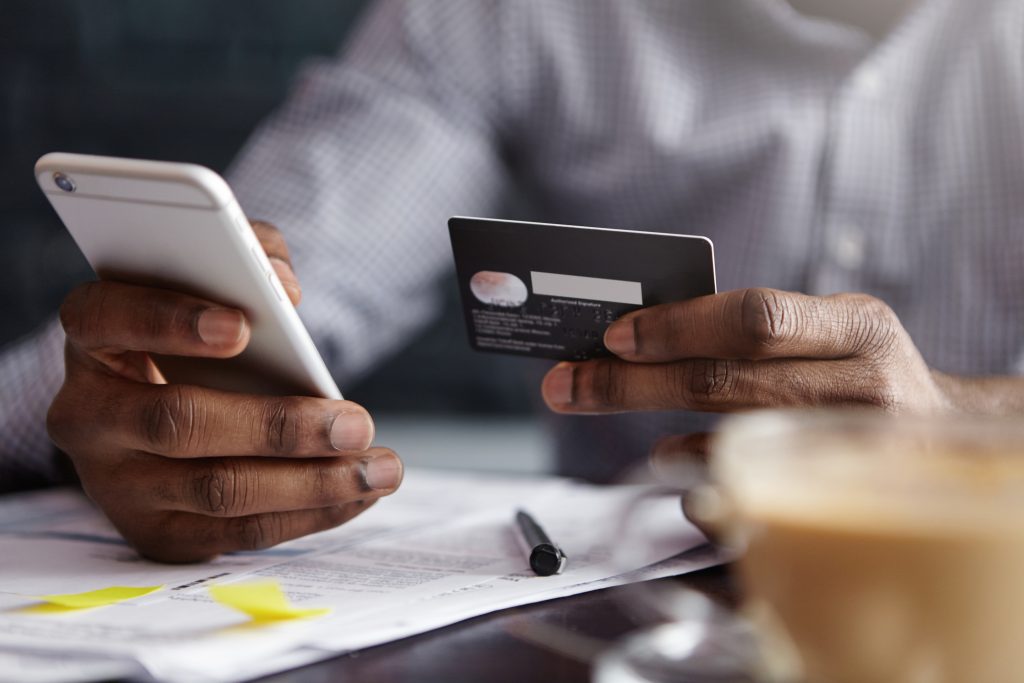 An image of a man making a payment online with his card