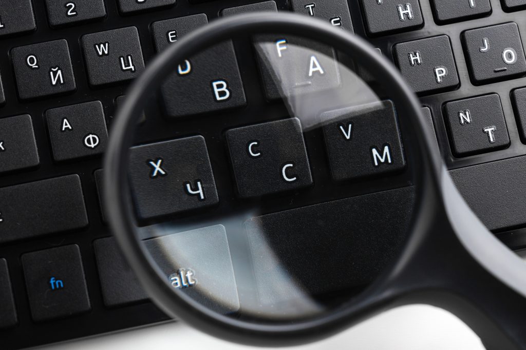 An image of a magnifying glass on a laptop pc keyboard