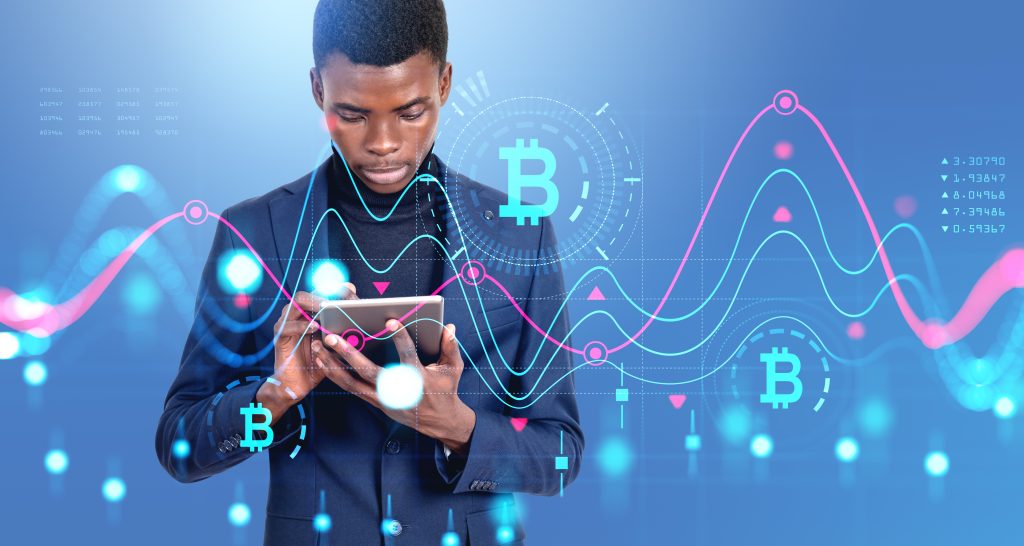 Black businessman working with tablet, virtual screen with bitcoin dynamics, candlesticks and glowing lines hud. Concept of financial communication and cryptocurrency