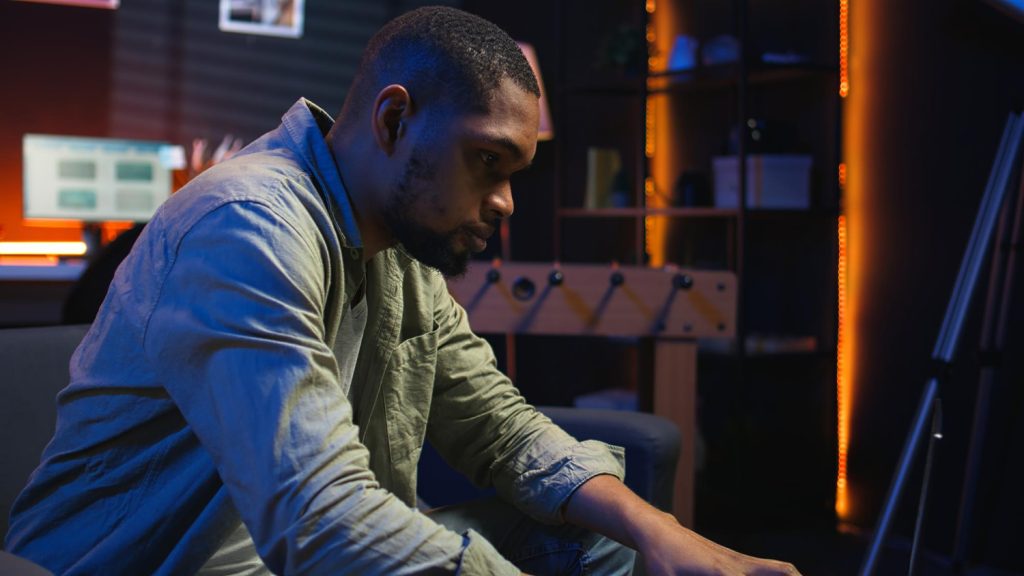 Thoughtful focused successful caucasian male stock investor, broker, financial adviser, sits at work desk, looks at computer, pensively analyze risks and prospects, rise or fall of cryptocurrency coin